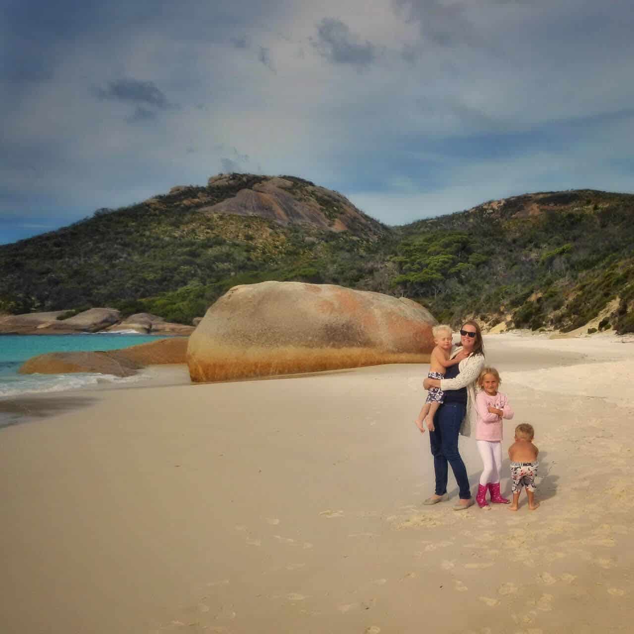 Keri from Our Globetrotters on a beach with her family