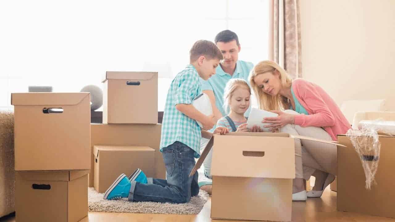 A family who are moving to Australia and surrounded by boxes