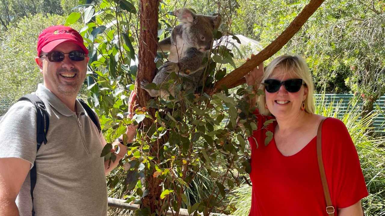 Tracy and Doug with a koala while housesitting in Australia